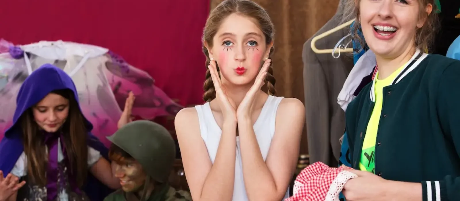 Theater assistant laughs as actress pouts at camera Theater assistant laughs as the young actress pouts at the camera